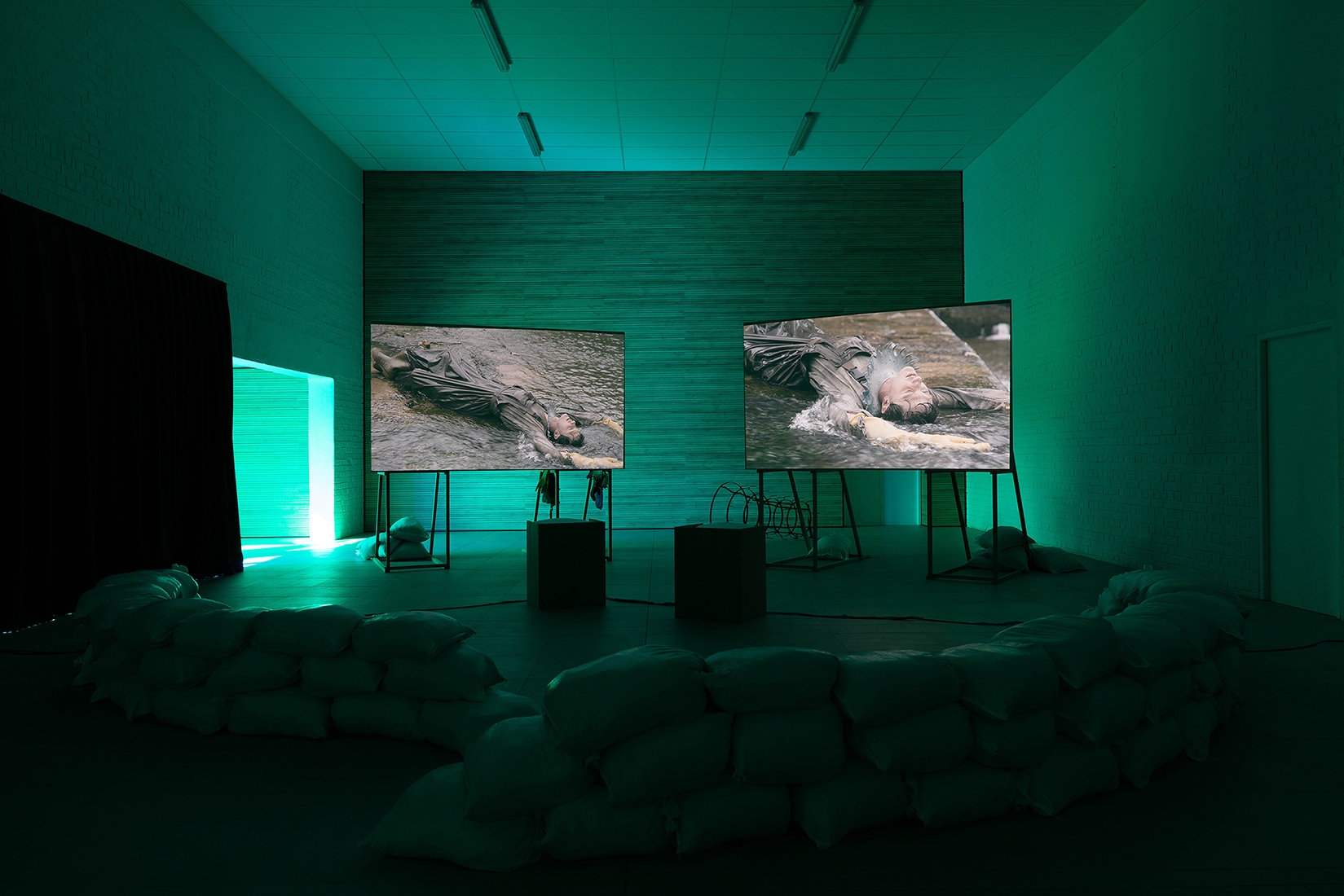http://mail.abrideswardt.com/files/gimgs/th-81_Installation view Abri de Swardt, Kammakamma (2022-2024), Synchronised two-channel projection, configurable screens, sand from Macassar Dunes, and costumes, 16’54 min.jpg
